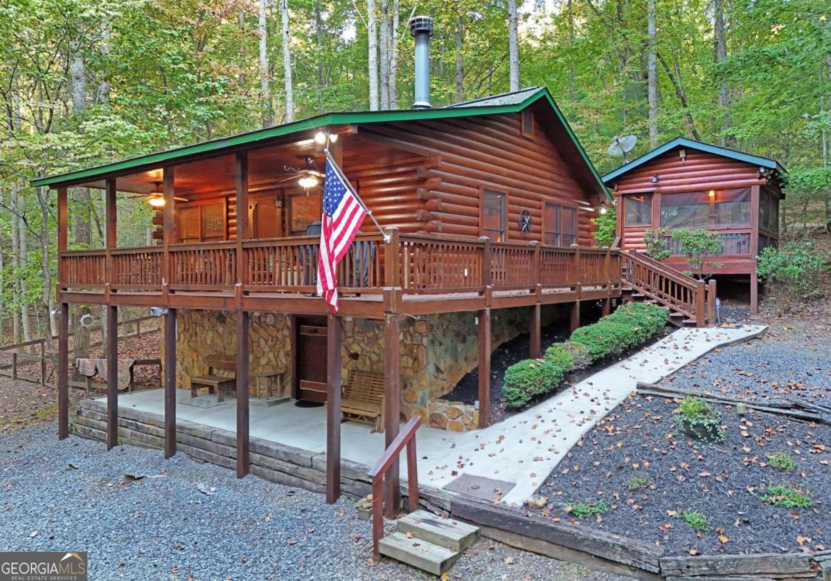 a view of a house with a yard balcony and furniture