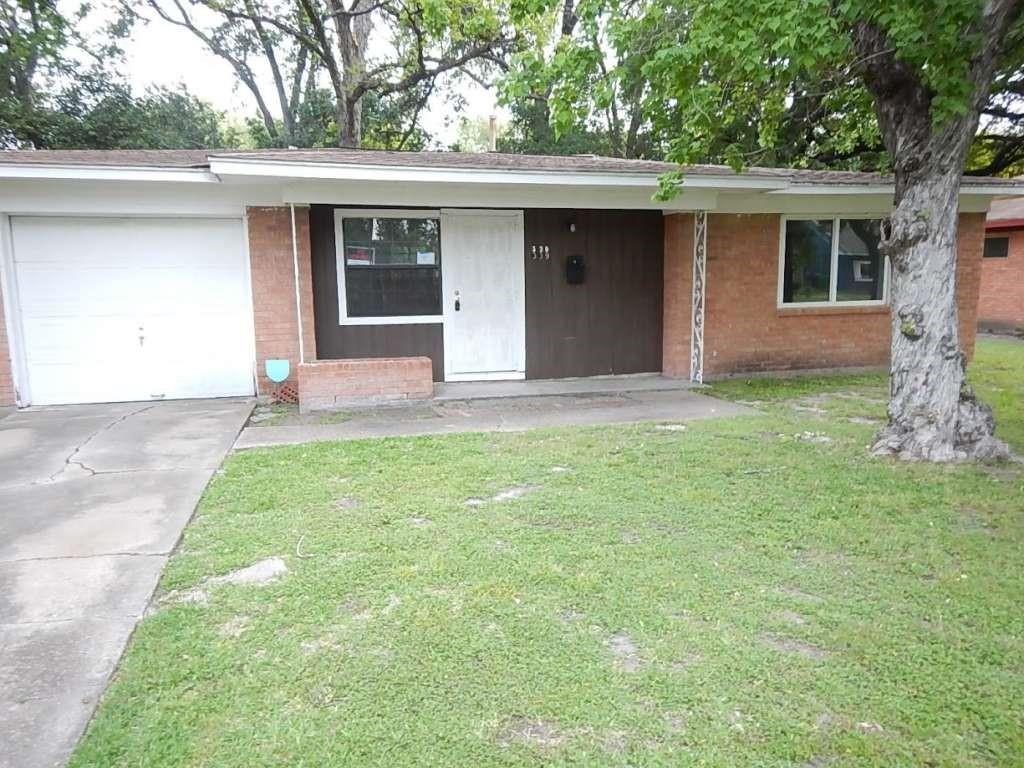 a front view of a house with a garden and yard