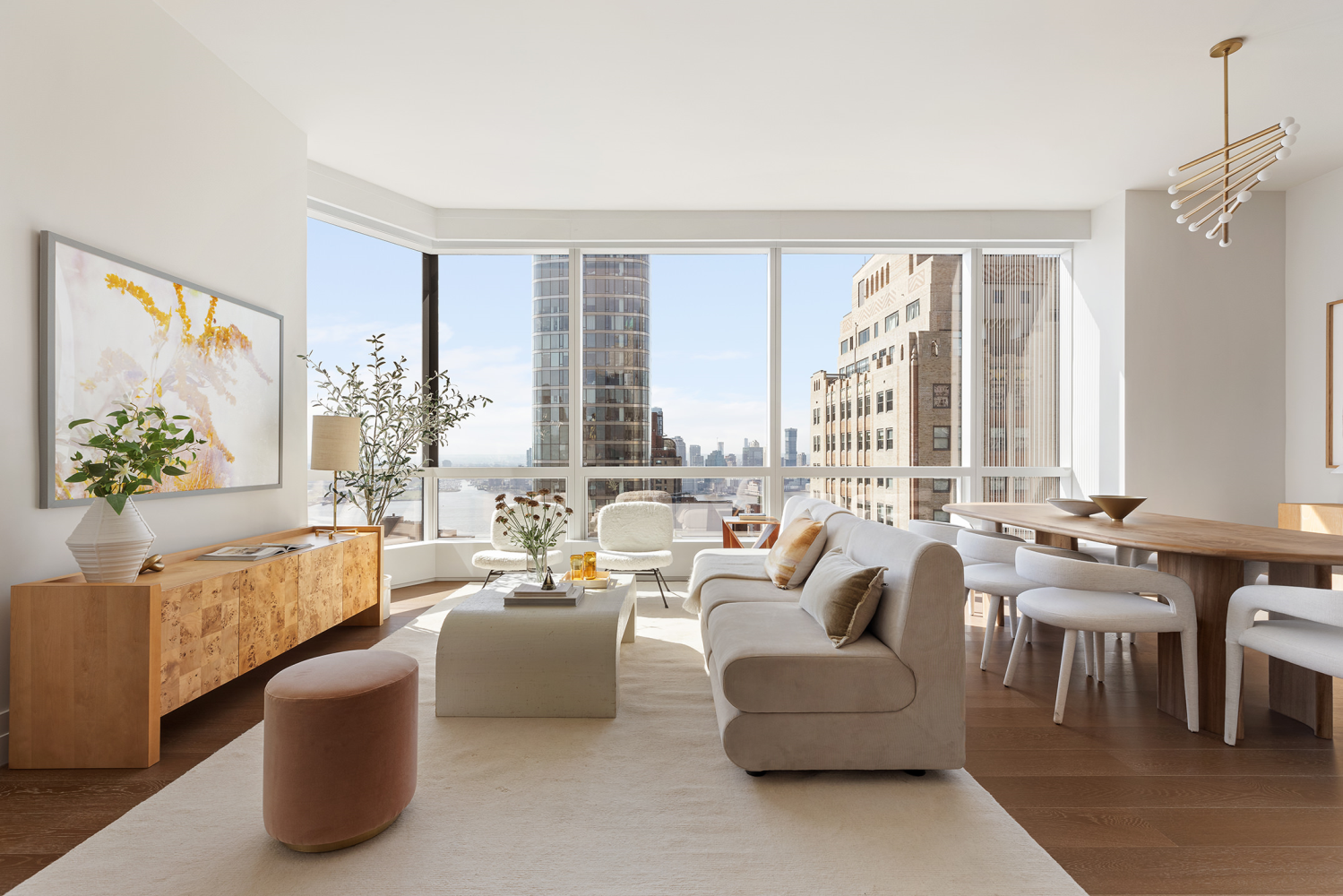 a living room with furniture and large windows