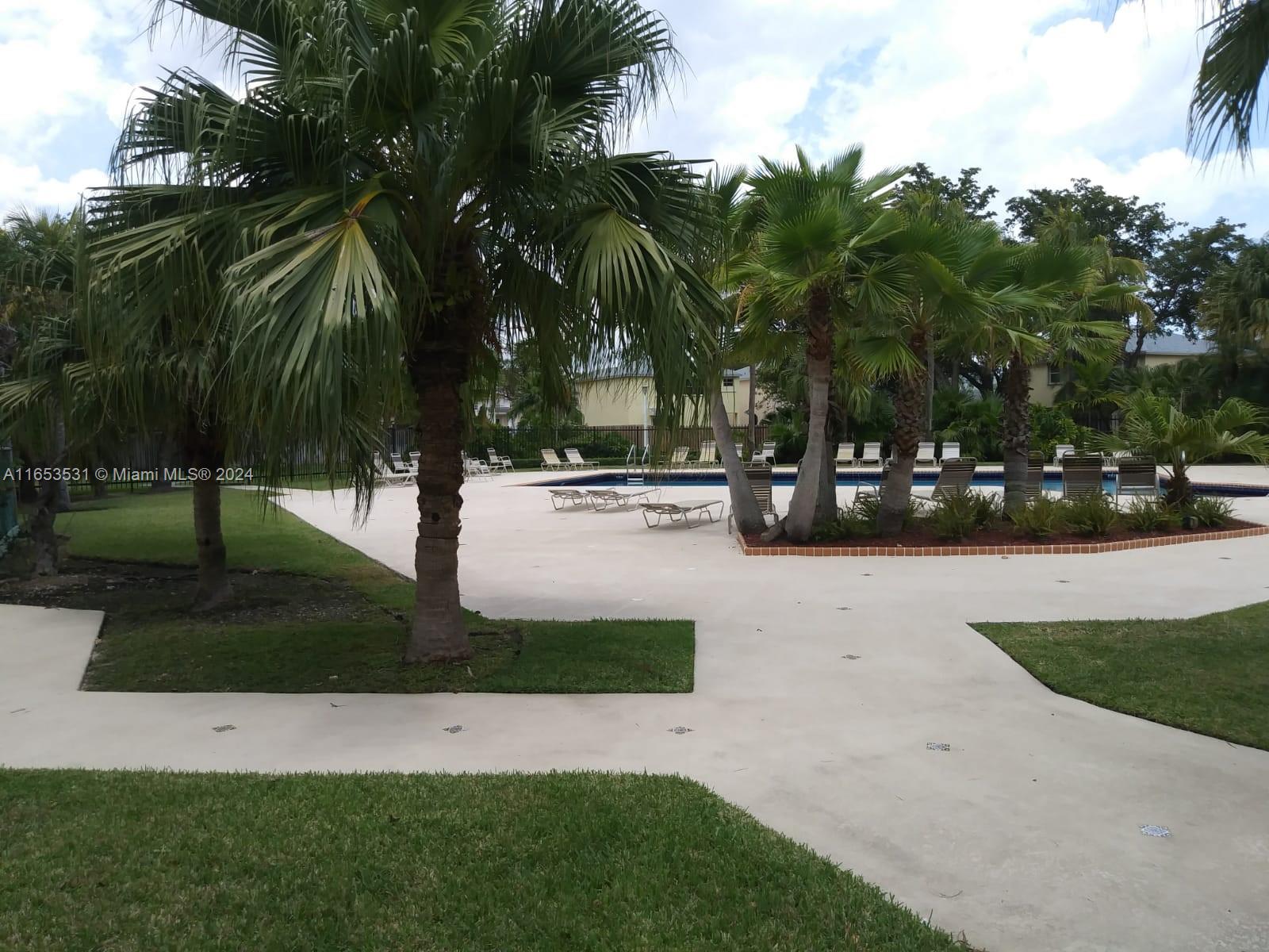 a view of outdoor space with garden and tree