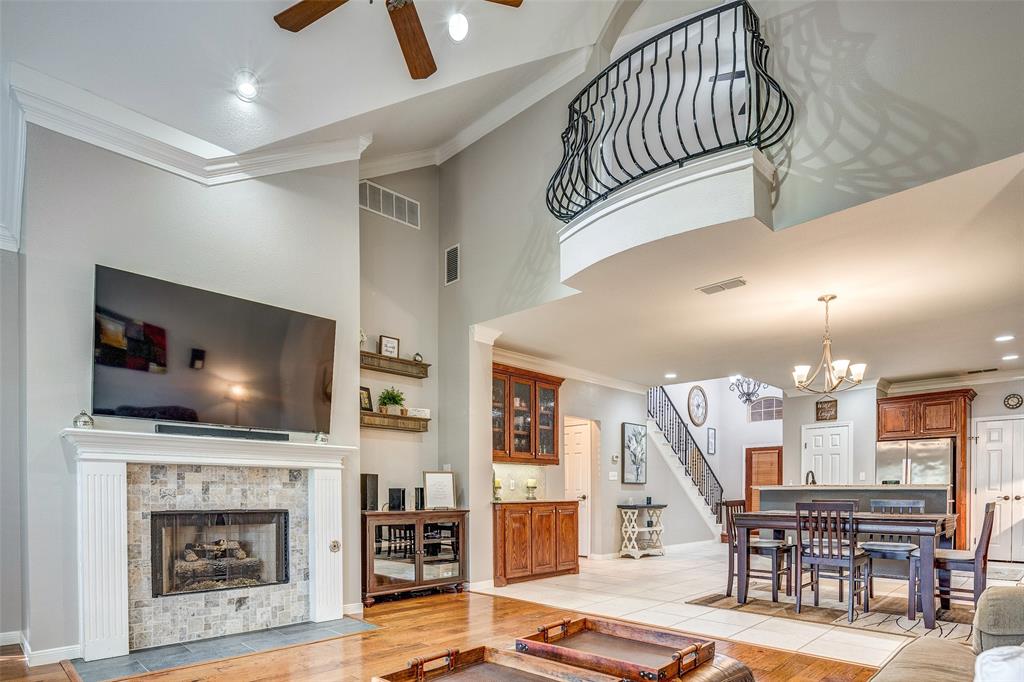 a living room with wooden floor and a flat screen tv