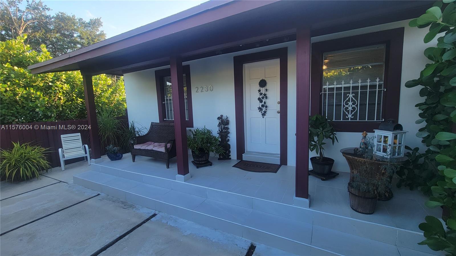 a view of a house with porch and furniture