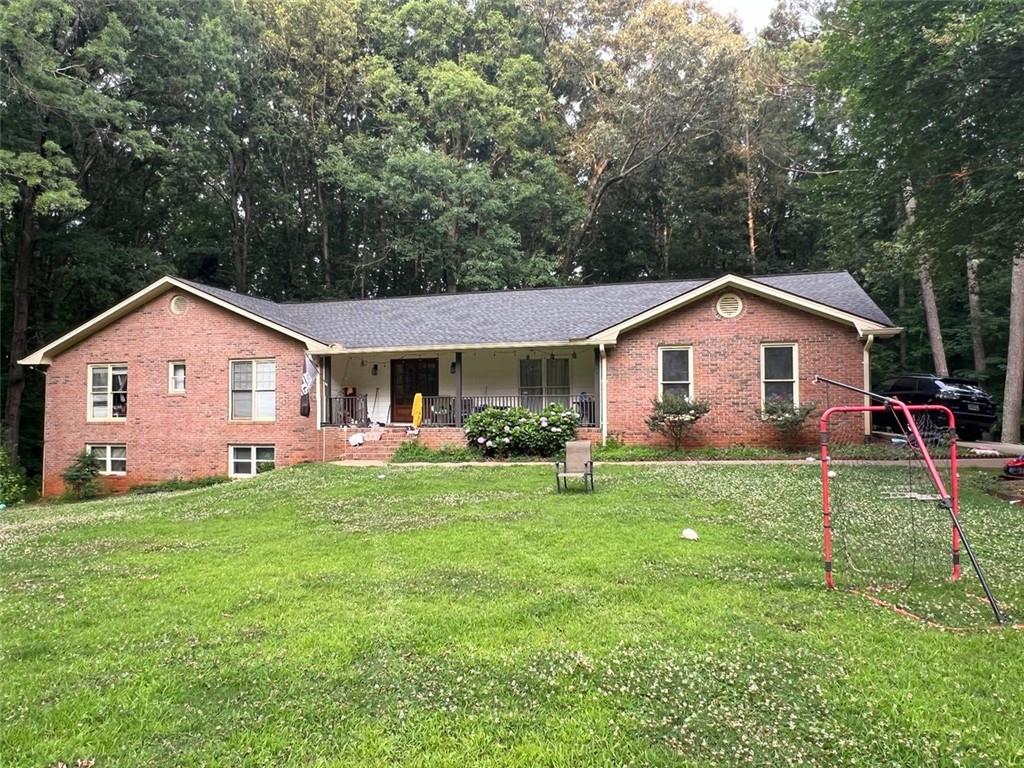 a front view of house with yard and green space