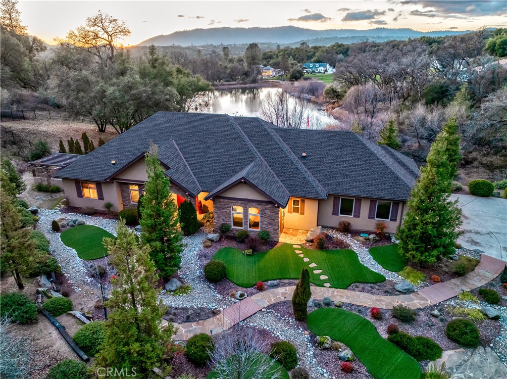 a view of house with a yard and a large pool