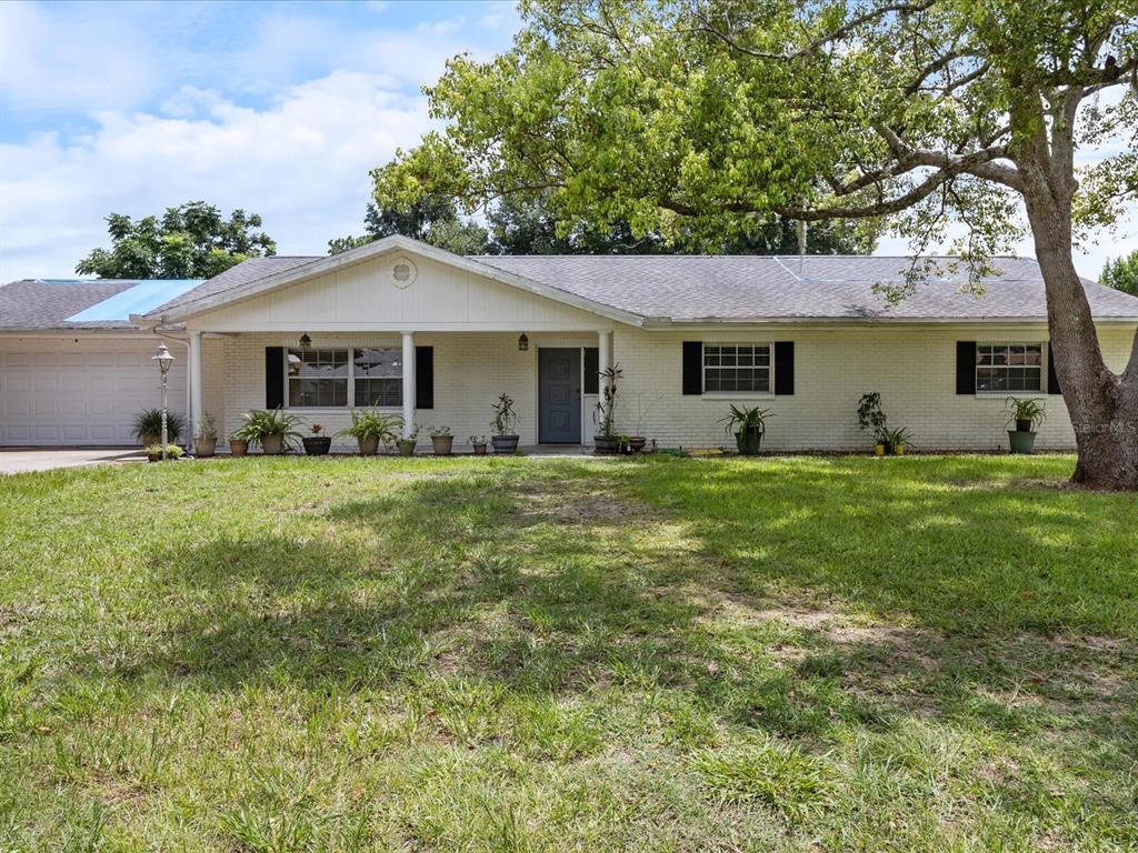 a front view of house with yard and green space