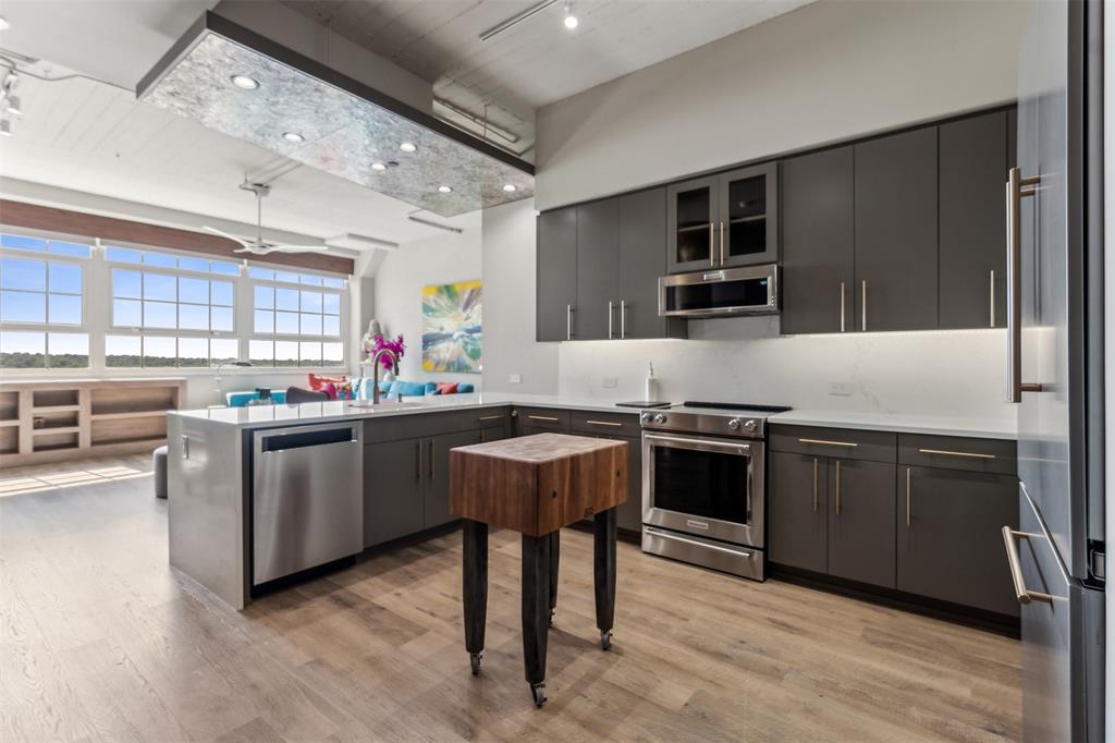 a kitchen with a sink appliances and cabinets