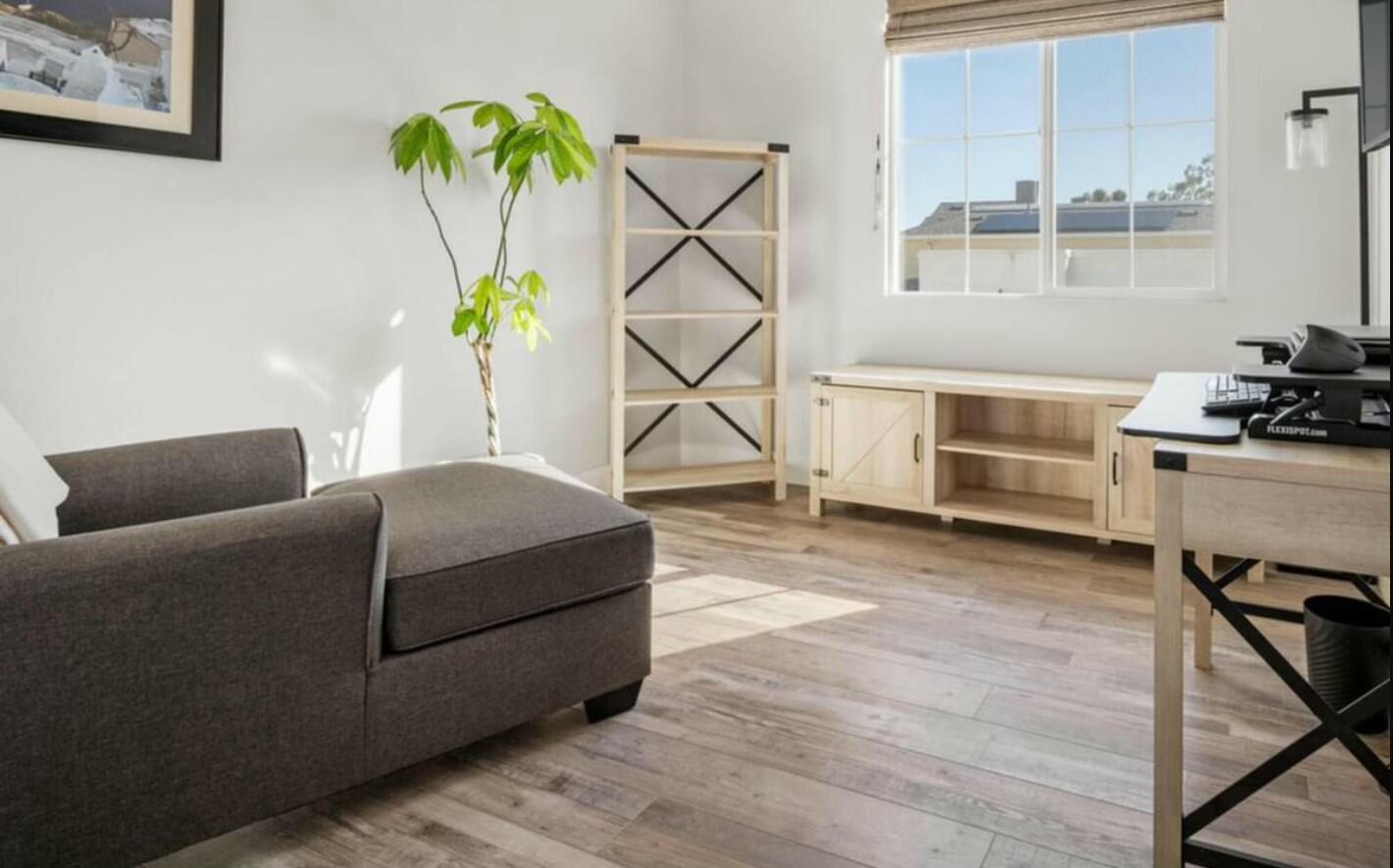 a living room with a couch and a wooden floor