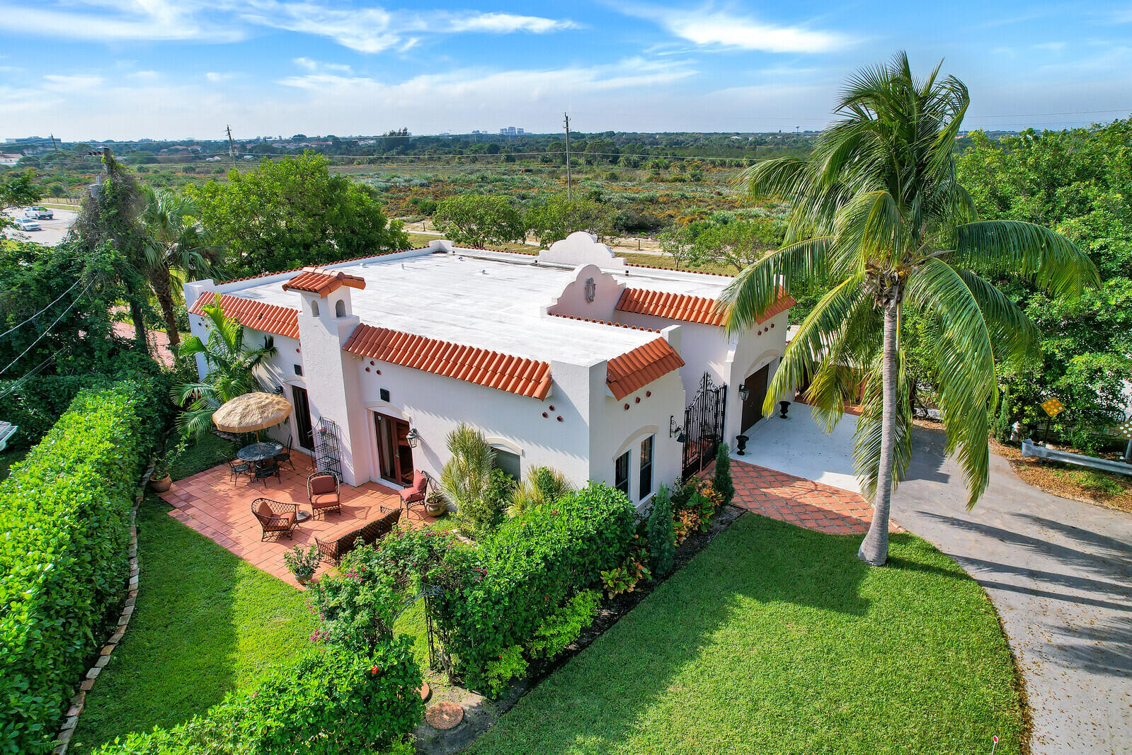 an aerial view of a house with a garden and lake view