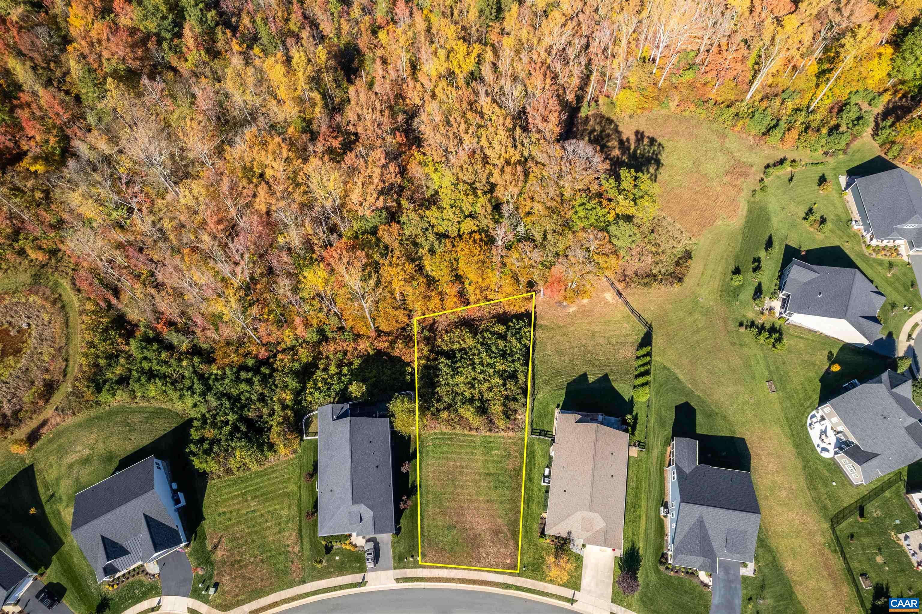 an aerial view of a residential apartment building with a yard