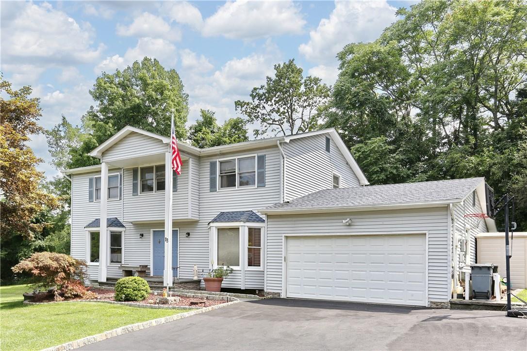 View of front facade with a front lawn and a garage