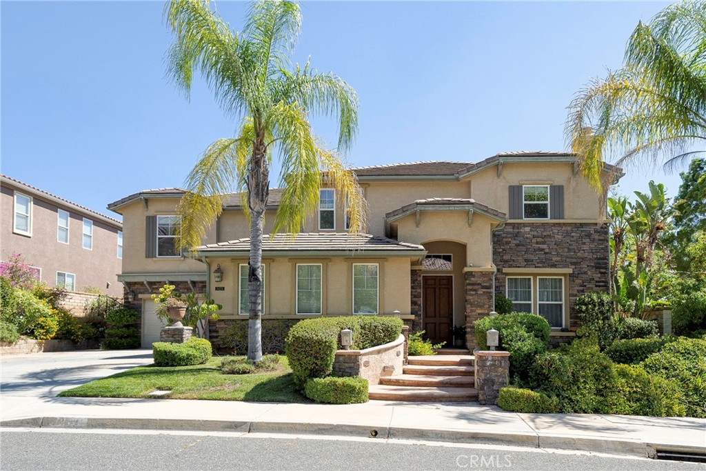 a front view of a house with a garden