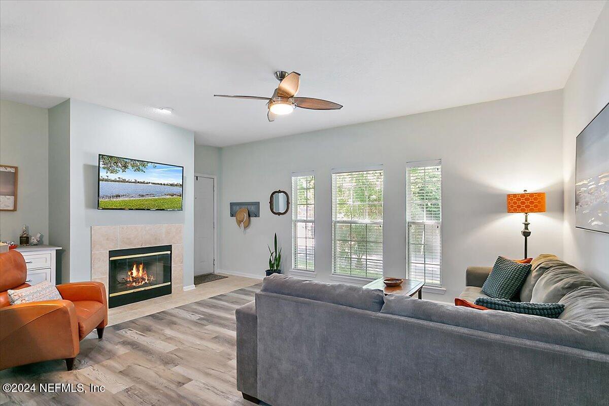 a living room with furniture a fireplace and a flat screen tv