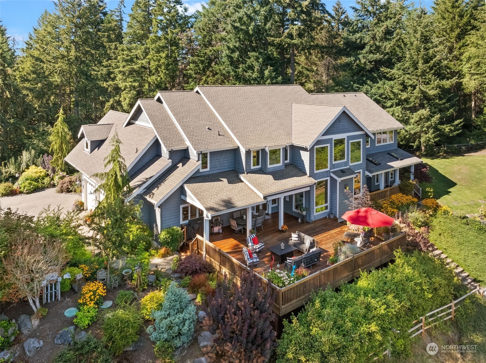 an aerial view of a house with swimming pool and big yard