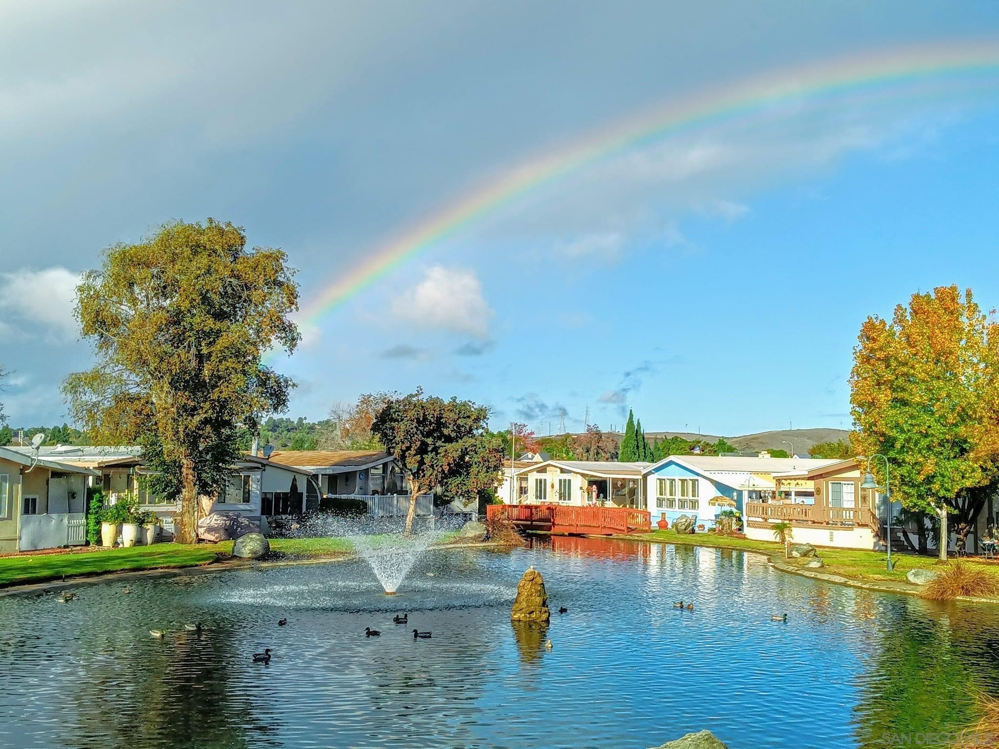 a view of residential houses with outdoor space and lake view