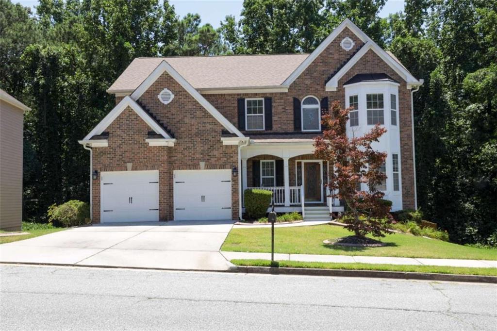 a front view of a house with a yard