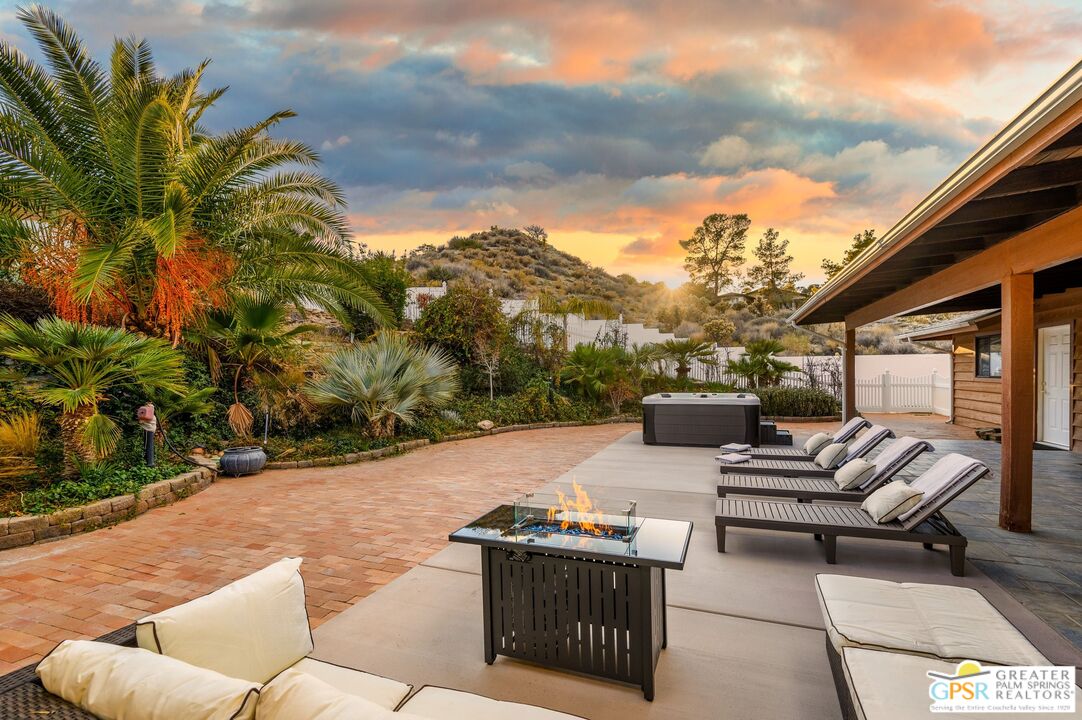 a backyard of a house with table and chairs