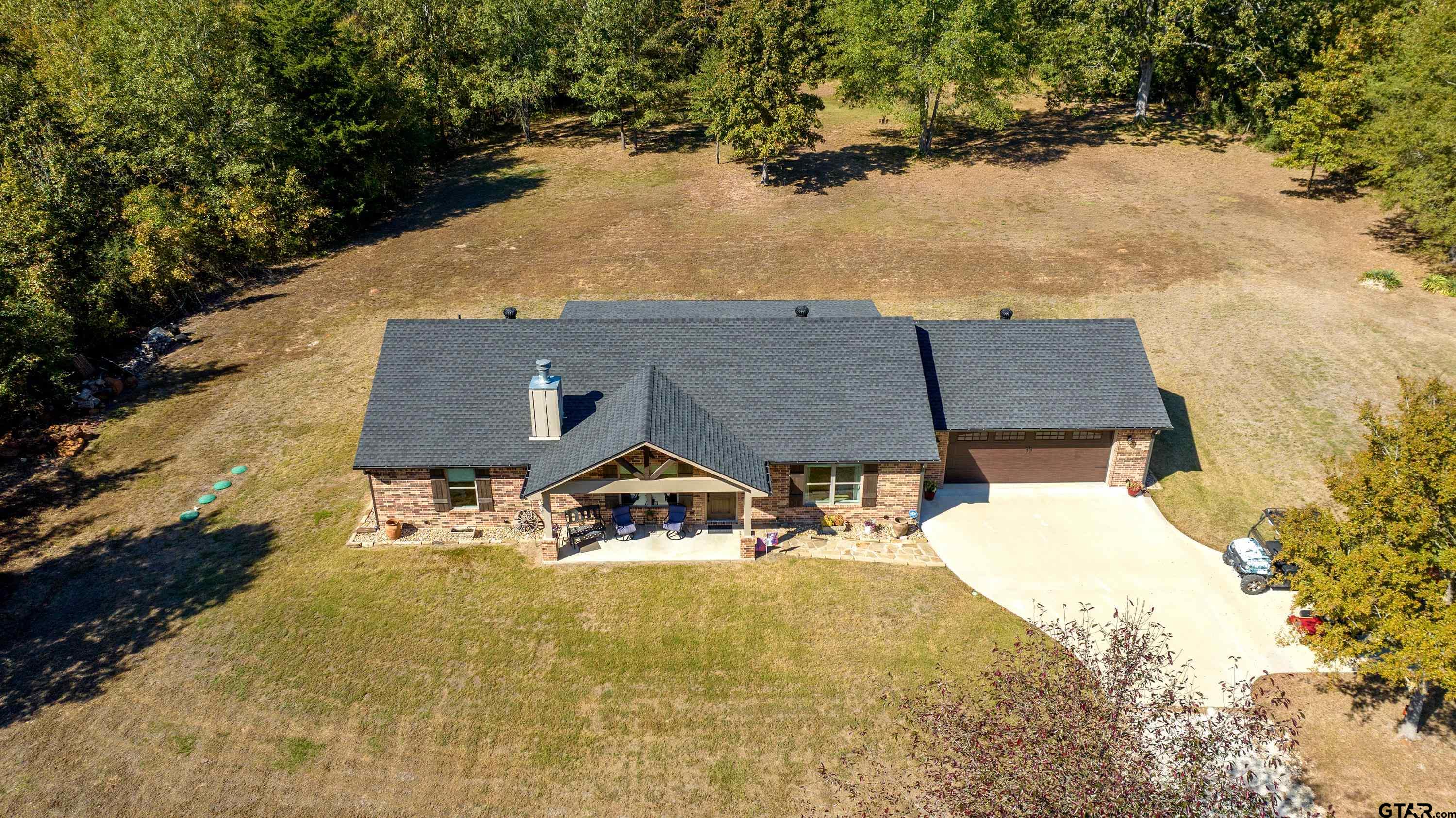 an aerial view of a house with a yard