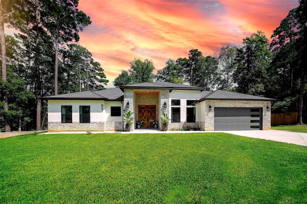 a front view of house with yard and green space