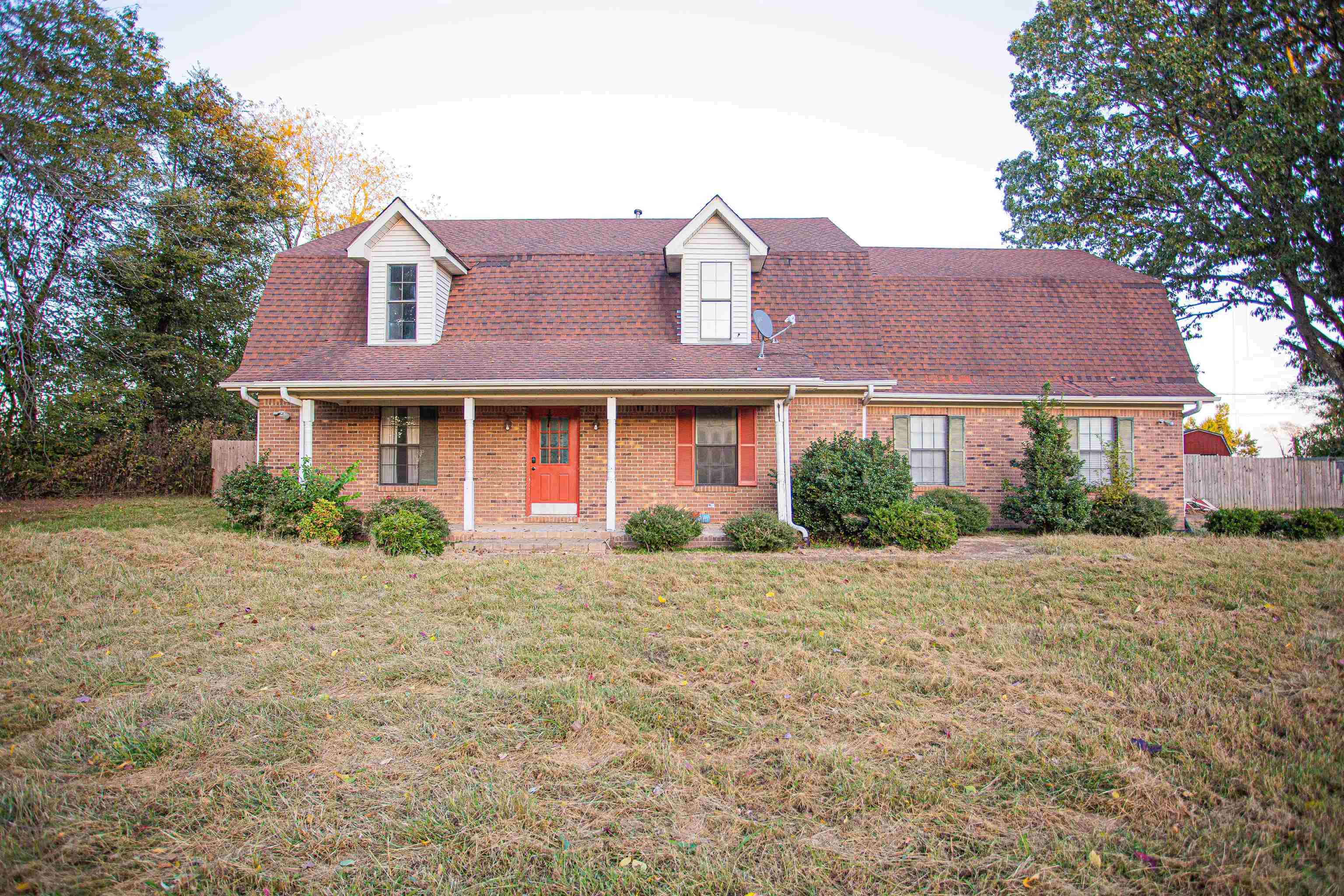 a front view of a house with yard and green space