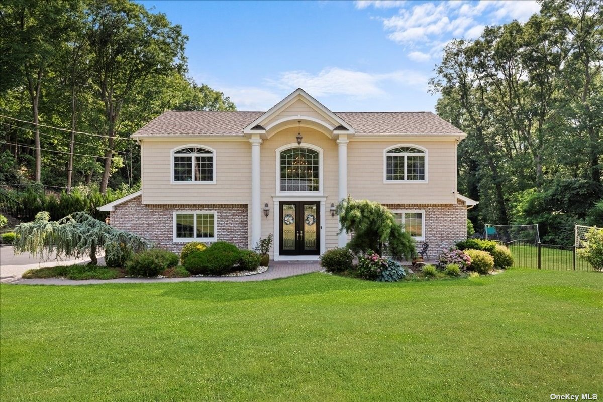 a front view of house with yard and green space