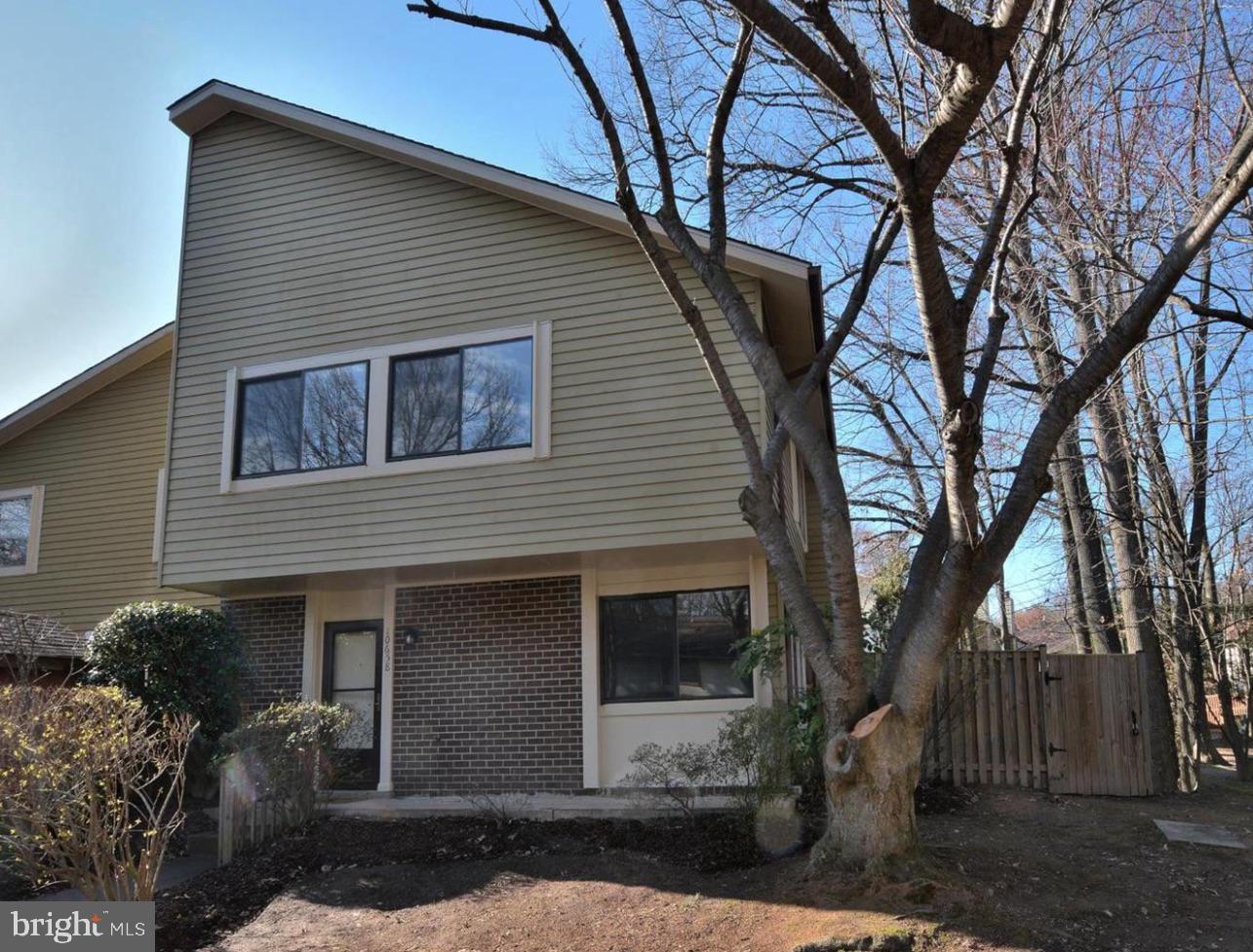 a house that has a tree in front of the house