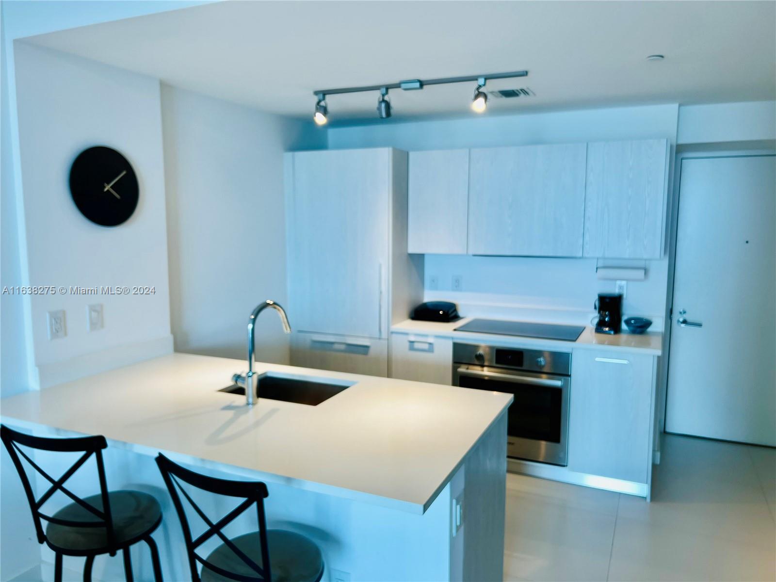 a kitchen with a table chairs and a stove