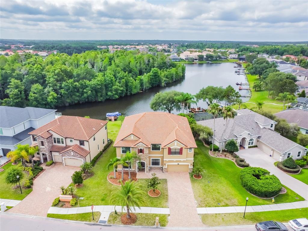 an aerial view of a house with a garden and lake view