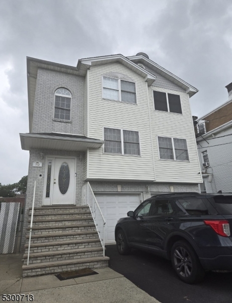 a front view of a house with a parking space