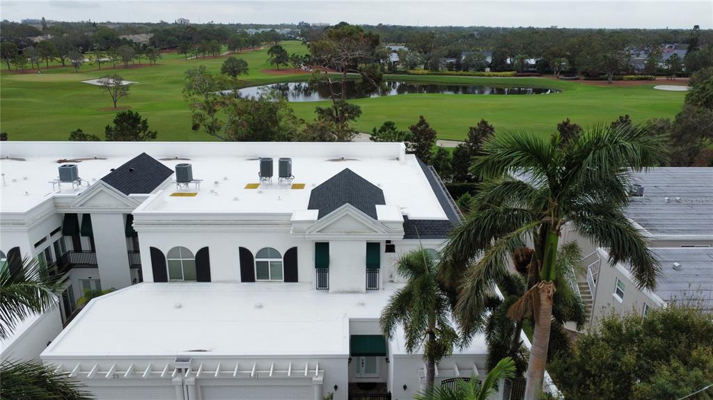 a view of a white house with a yard