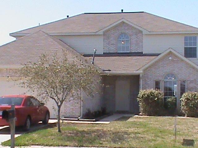 a view of a house with a yard and garage