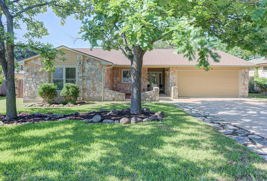 a front view of house with yard and green space