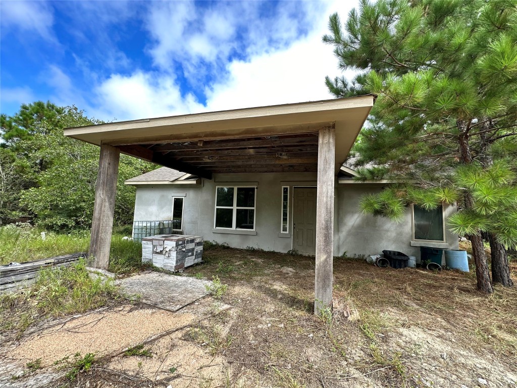 a view of house with backyard space and sitting area