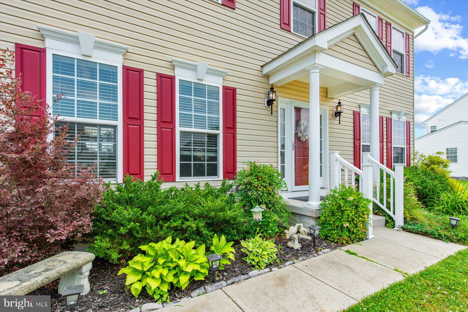 a view of a house with potted plants