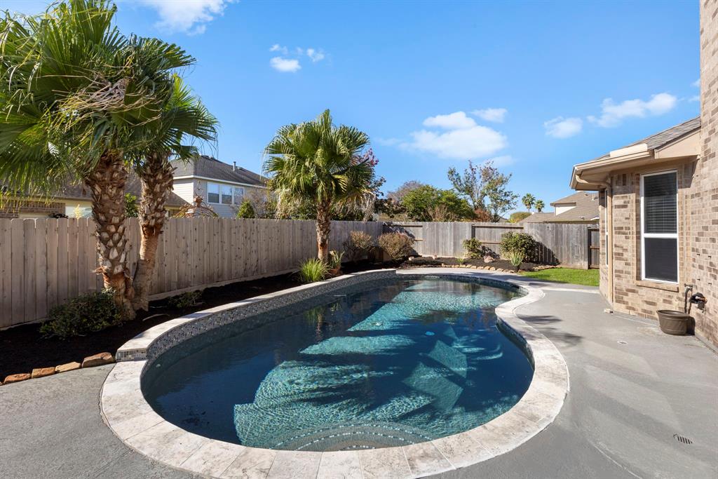 a view of a swimming pool with a sitting area