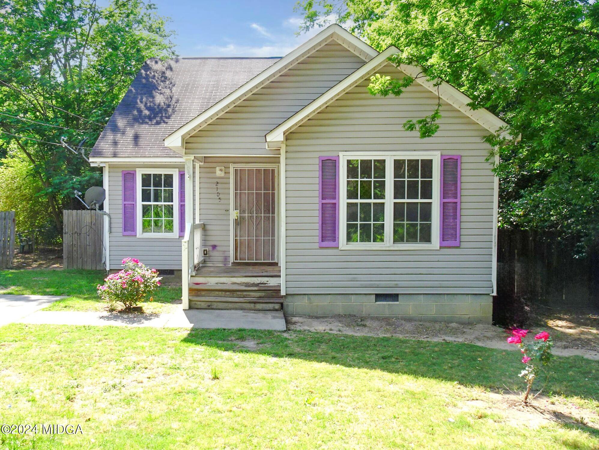 a front view of a house with garden