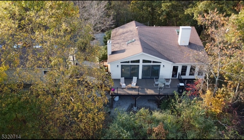 an aerial view of a house with a yard and trees