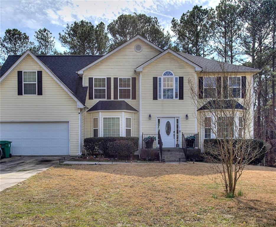 a front view of a house with a yard