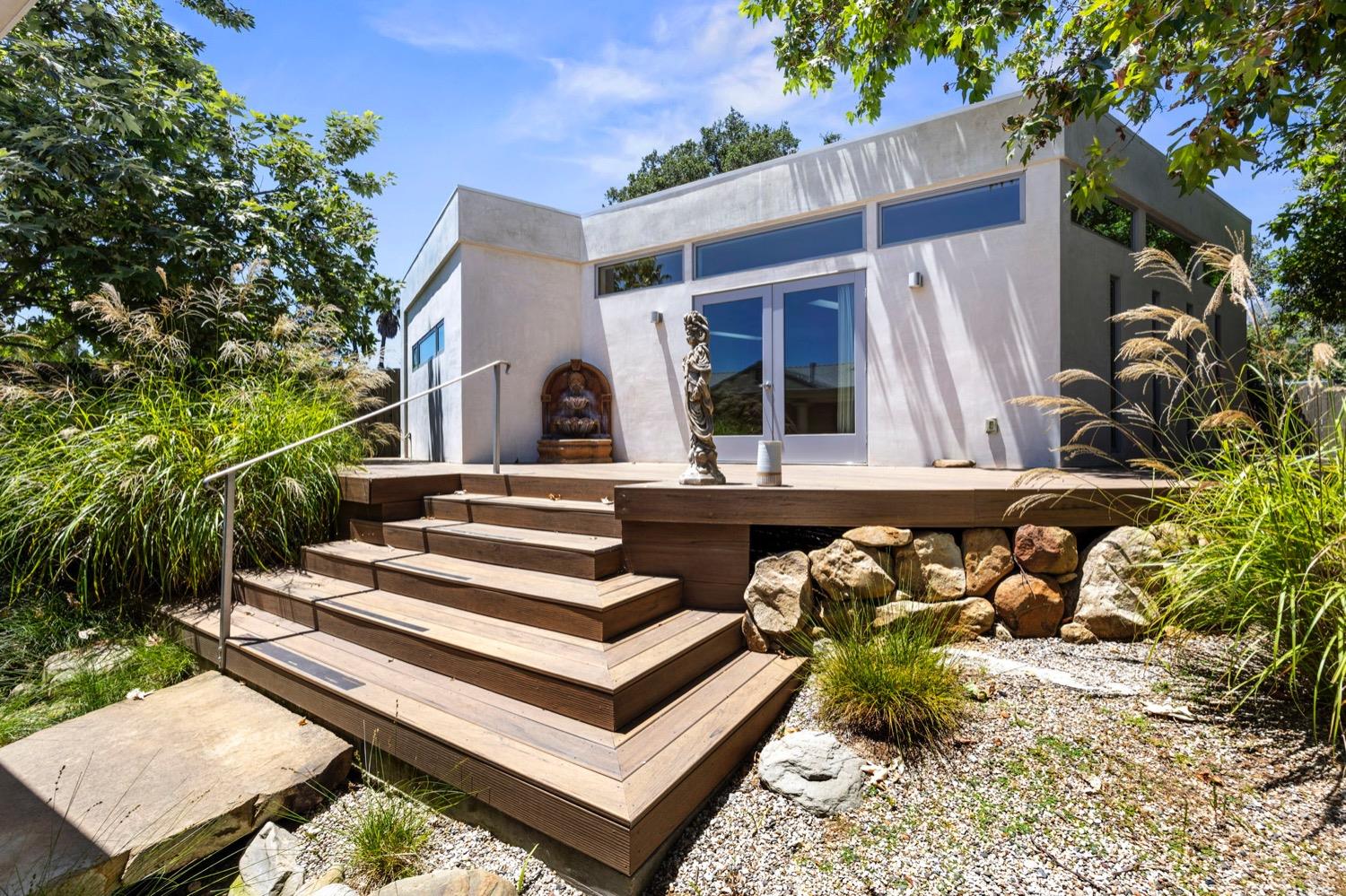 a view of a house with backyard and sitting area