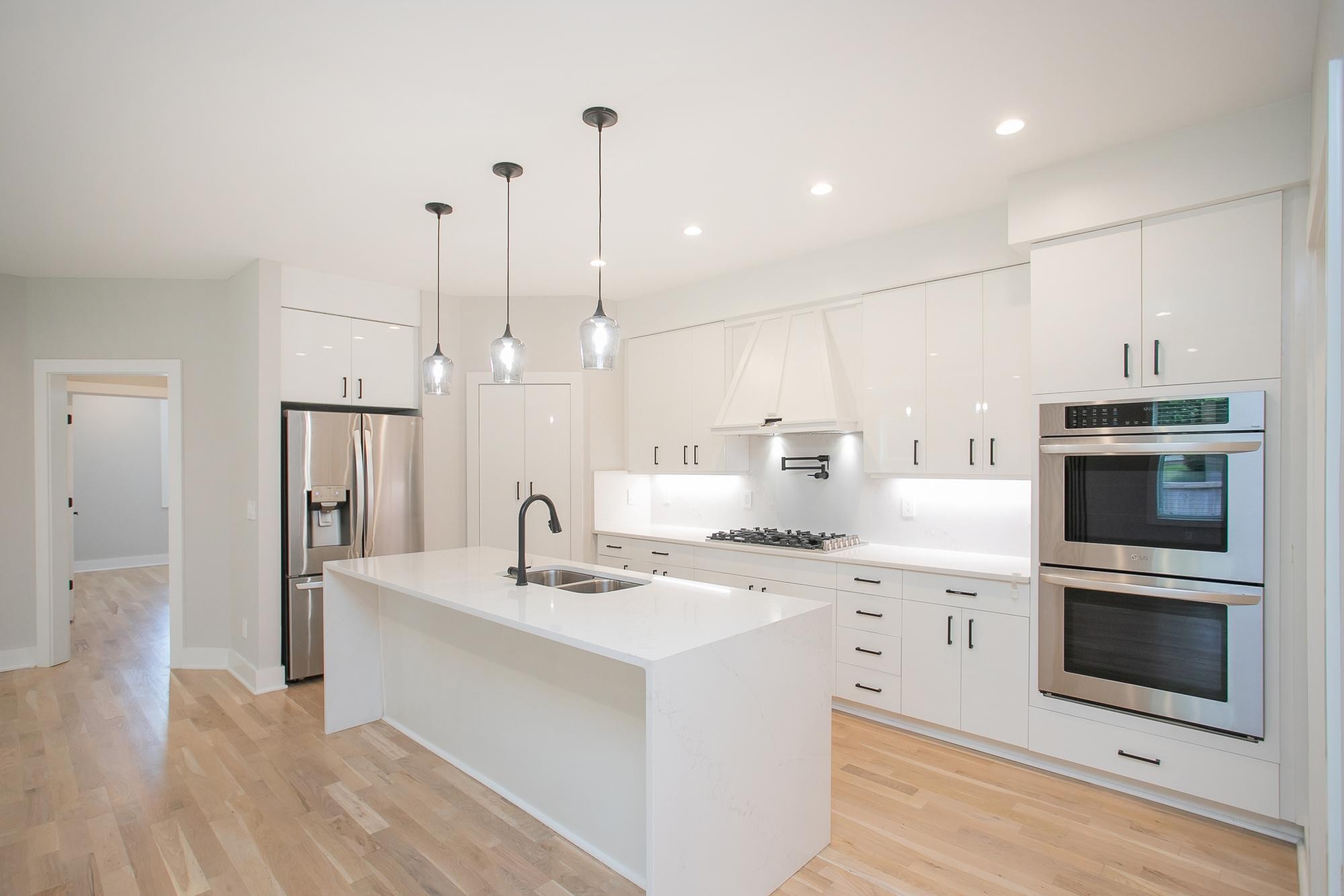 a kitchen with a sink stainless steel appliances and cabinets