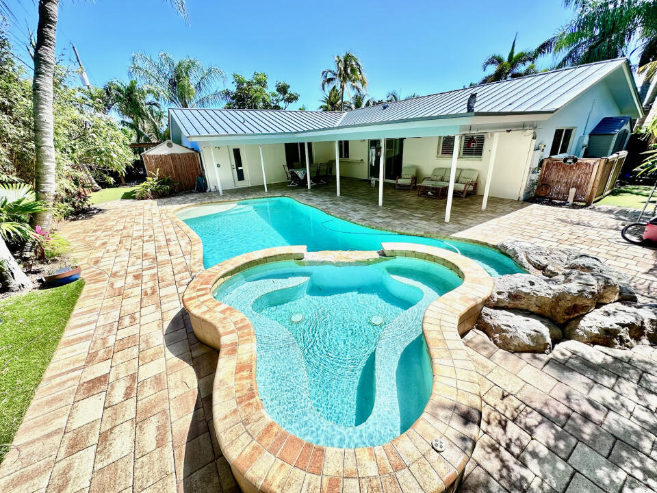 a view of a white house with a swimming pool