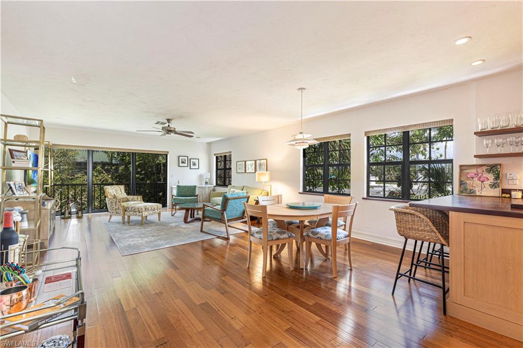 a dining room with furniture window and wooden floor