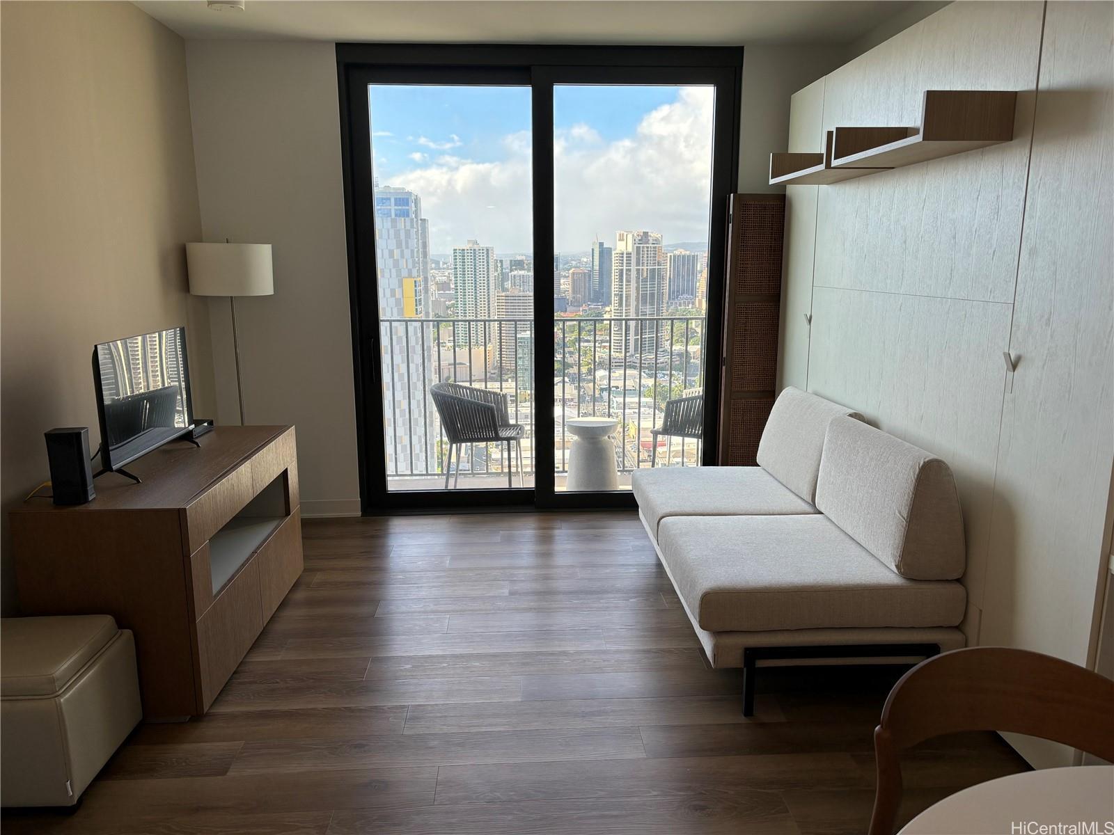 a living room with furniture and a floor to ceiling window