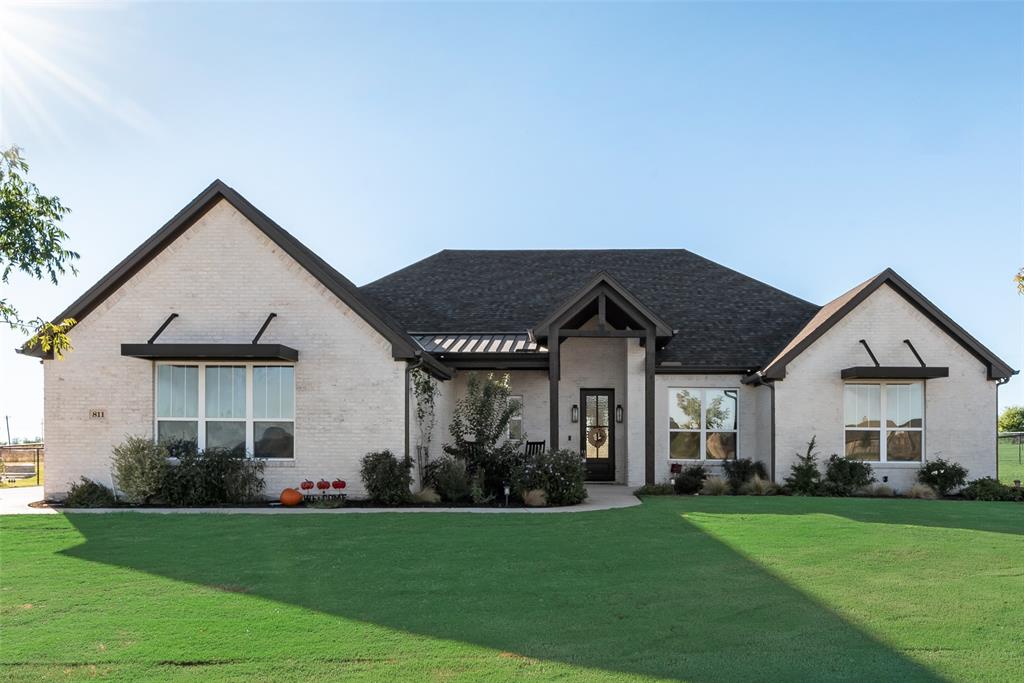 a front view of house with yard and green space