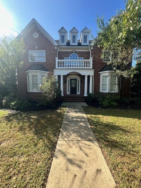 a view of front of house with a yard