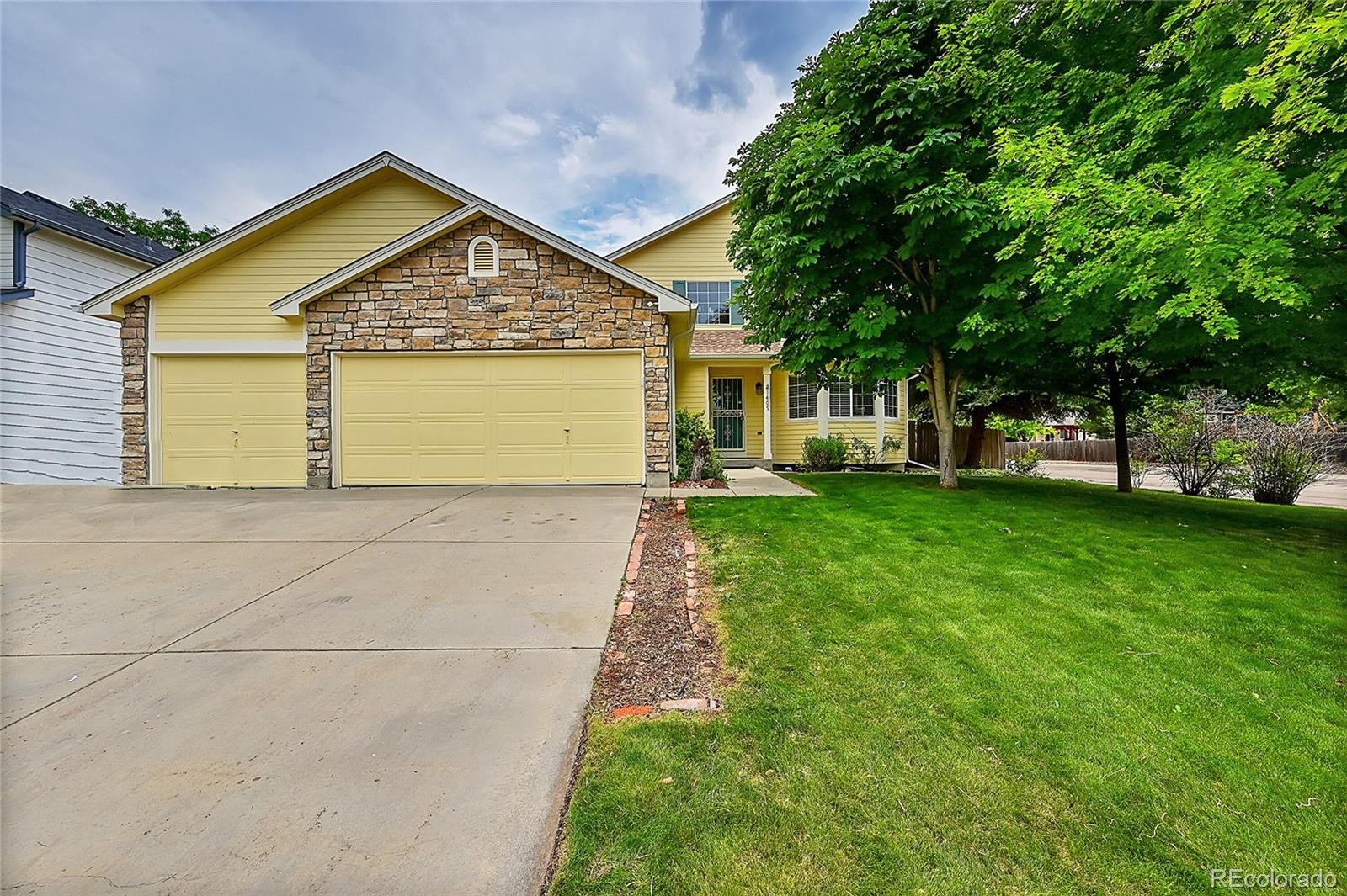 a view of a house with a yard and tree s