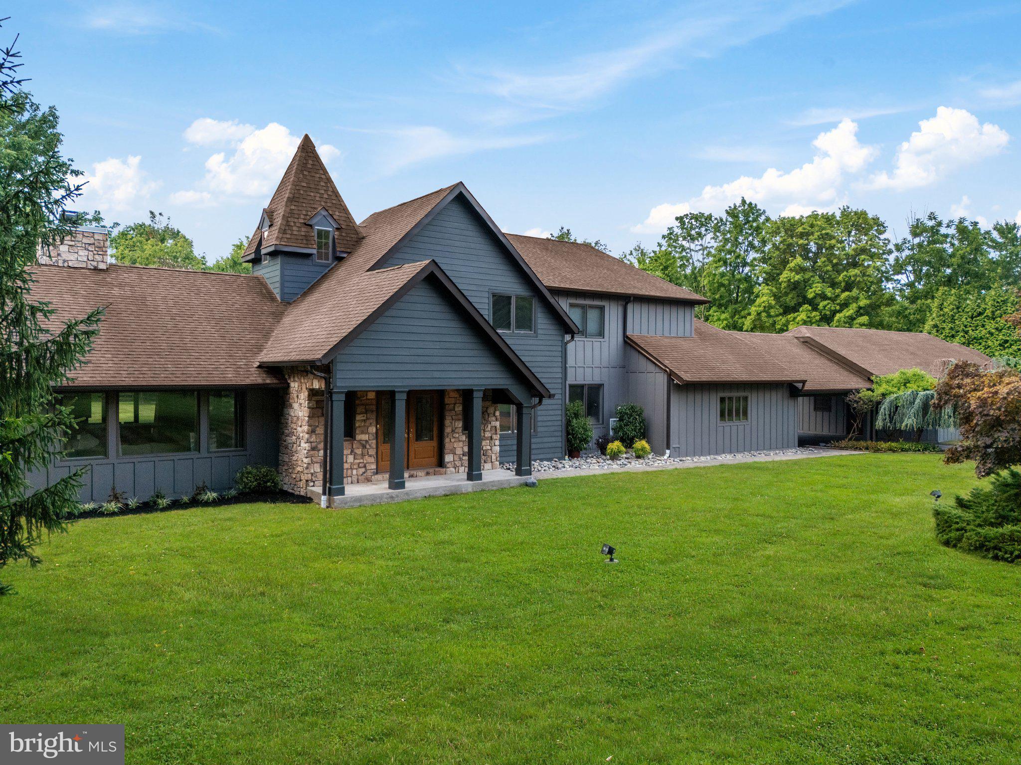 a front view of a house with a garden and yard