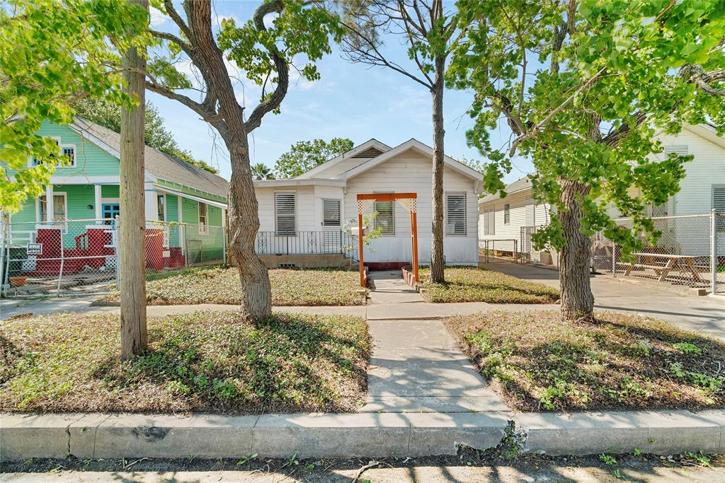 front view of a house with a tree in the yard