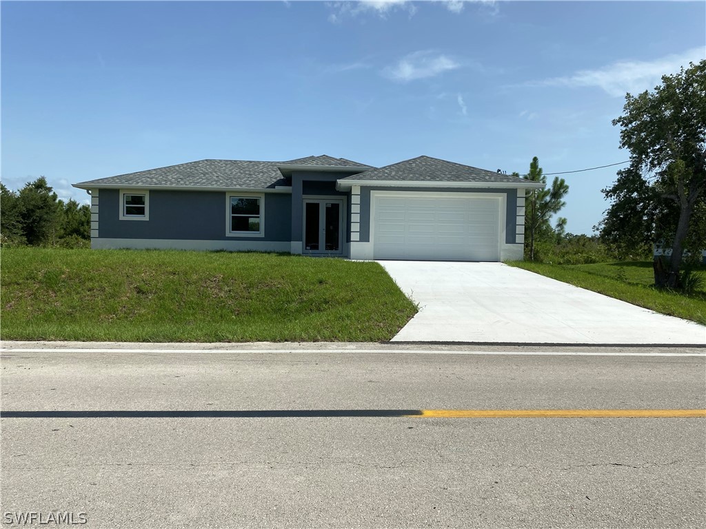 a front view of a house with a yard and garage