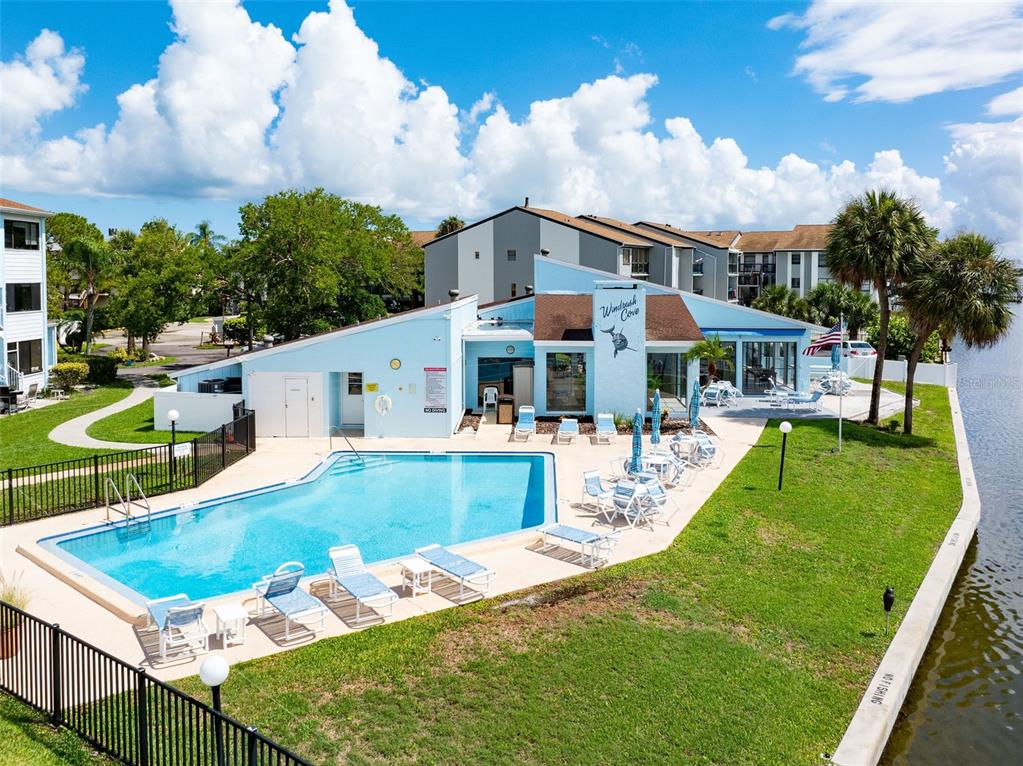 a view of a house with swimming pool and sitting area