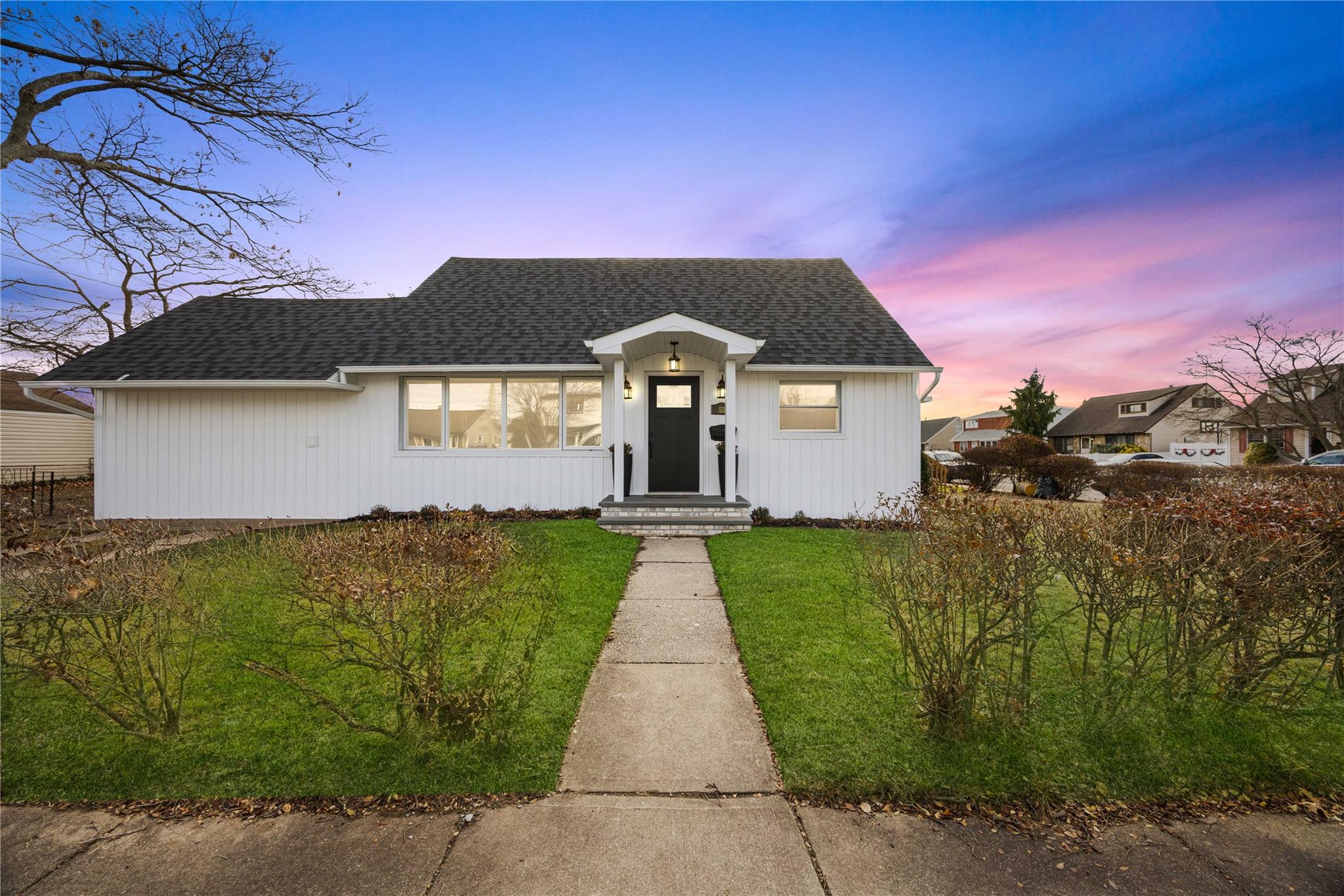 View of front of property with a lawn